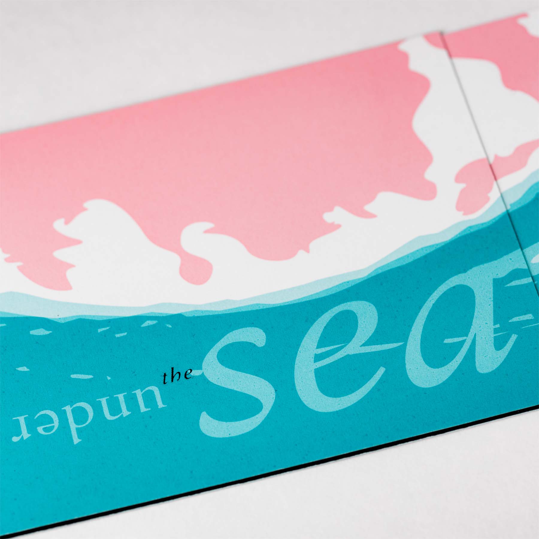 Front of trifold 'join us inder the sea' birthday party invitation for three year old, beginning a descent under water.