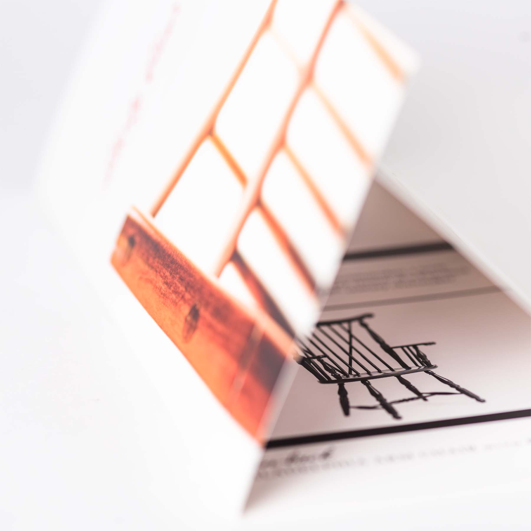 Partially opened brochure cover, shallow depth of field.